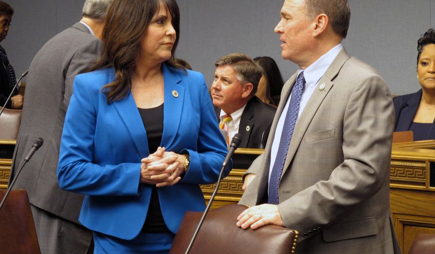 Reps. Dodie Horton, R-Haughton, left, and Alan Seabaugh, R-Shreveport, talk ahead of the House Ways and Means Committee hearing, on Sunday, Feb. 25, 2018, in Baton Rouge, La. The lawmakers voted against both major tax bills advanced by the committee. (AP Photo/Melinda Deslatte)