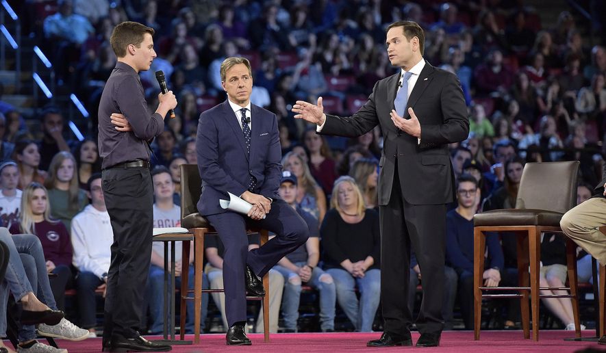 In this Feb. 21, 2018 photo, Marjory Stoneman Douglas High School student Cameron Kasky asks a question to Sen. Marco Rubio during a CNN town hall meeting at the BB&amp;amp;T Center in Sunrise, Fla.  Red, blue or purple, in flyover country or along the U.S. coast, most Americans loathe the national legislature and think its members are listening to all the wrong people.   (Michael Laughlin/South Florida Sun-Sentinel via AP)