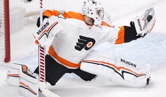 Philadelphia Flyers goaltender Petr Mrazek (34) makes a glove save against the Montreal Canadiens during third period NHL hockey action Monday, Feb. 26, 2018 in Montreal. (Ryan Remiorz/The Canadian Press via AP)