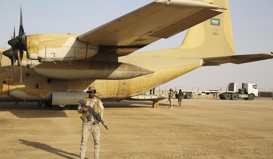 In this Feb. 1, 2018 photo, a Saudi soldier guards an aid flight at an air base in Marib, Yemen. Saudi Arabia under King Salman and Crown Prince Mohammed bin Salman has replaced its military chief of staff and other defense officials amid its stalemated war in Yemen early Tuesday, Feb. 27, 2018. (AP Photo/Jon Gambrell)