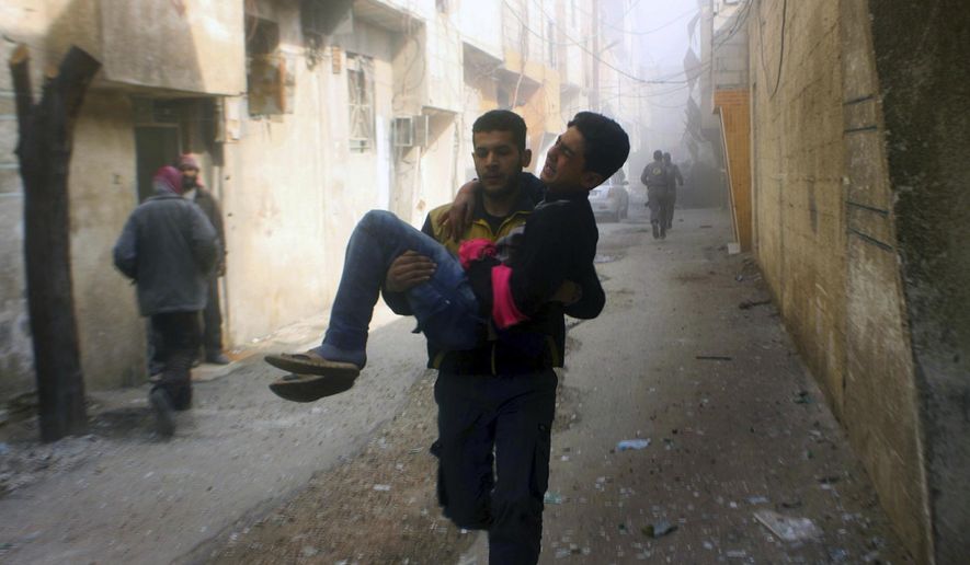 This photo released on Saturday, Feb 24, 2018, by the Syrian Civil Defense group known as the White Helmets, shows members of the Syrian Civil Defense group carrying a young man who was wounded during airstrikes and shelling by Syrian government forces, in Ghouta, a suburb of Damascus, Syria. A new wave of airstrikes and shelling on eastern suburbs of the Syrian capital Damascus left at least 22 people dead and more than a dozen wounded Saturday, raising the death toll of a week of bombing in the area to nearly 500, including scores of women and children. (Syrian Civil Defense White Helmets via AP)