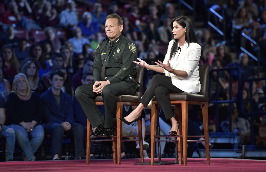 National Rifle Association spokesperson Dana Loesch answers a question while sitting next to Broward Sheriff Scott Israel during a CNN town hall meeting, Wednesday, Feb. 21, 2018, at the BB&amp;T Center, in Sunrise, Fla. (Michael Laughlin/South Florida Sun-Sentinel via AP)