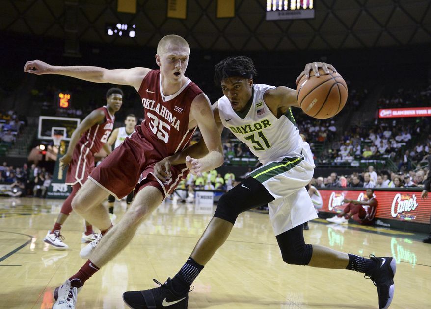 Baylor forward Terry Maston, right, is guarded by Oklahoma forward Brady Manek while driving to the basket during the first half of an NCAA college basketball game Tuesday, Feb. 27, 2018, in Waco, Texas. (Ernesto Garcia/Waco Tribune Herald via AP)