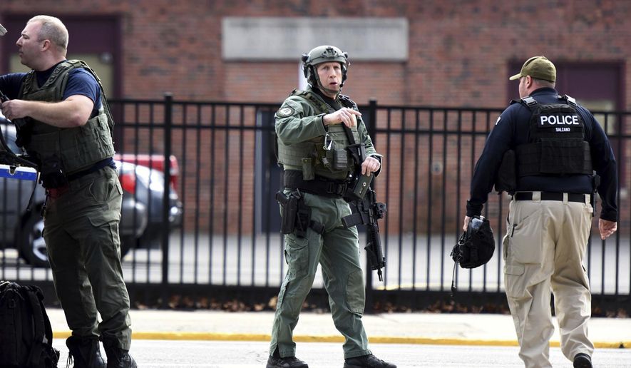 Members of SWAT prepare to enter Dumont High School while the school is under lockdown in Dumont, N.J., Monday Feb. 26, 2018. A New Jersey high school student was taken into custody after a reported social media threat that prompted the lockdown and a SWAT team response. (Amy Newman/The Record via AP)