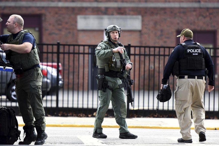 Members of SWAT prepare to enter Dumont High School while the school is under lockdown in Dumont, N.J., Monday Feb. 26, 2018. A New Jersey high school student was taken into custody after a reported social media threat that prompted the lockdown and a SWAT team response. (Amy Newman/The Record via AP)