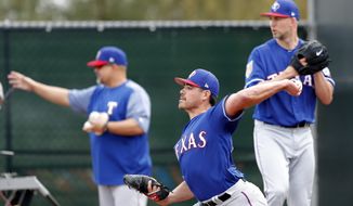 FILE - In this Feb. 15, 2018, file photo, Texas Rangers pitcher Matt Moore throws during a baseball spring training workout, in Surprise, Ariz. Moore hopes for a revival with the Rangers after tying for the most losses in the NL last season in San Francisco. (AP Photo/Charlie Neibergall, File)