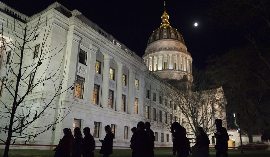 Public school personnel shown are seen leaving the West Virginia Capitol grounds in Charleston, W.Va., in this Tuesday, Feb. 27, 2018. (Craig Hudson/Charleston Gazette-Mail via AP) **FILE**