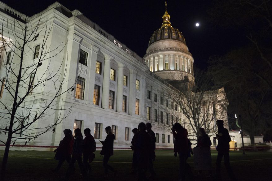 Public school personnel shown are seen leaving the West Virginia Capitol grounds in Charleston, W.Va., in this Tuesday, Feb. 27, 2018. (Craig Hudson/Charleston Gazette-Mail via AP) **FILE**
