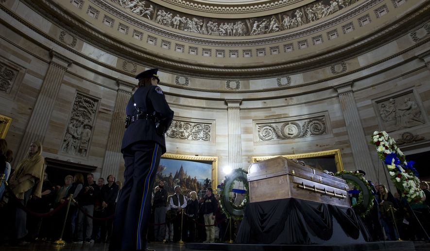 Visitors pay their respects as the casket of Reverend Billy Graham lies in honor at the Rotunda of the U.S. Capitol Building in Washington, Wednesday, Feb. 28, 2018. It's a rare honor for a private citizen to lie in honor at the Capitol. Graham died Wednesday in his sleep at his North Carolina home. He was 99. (AP Photo/Jose Luis Magana)