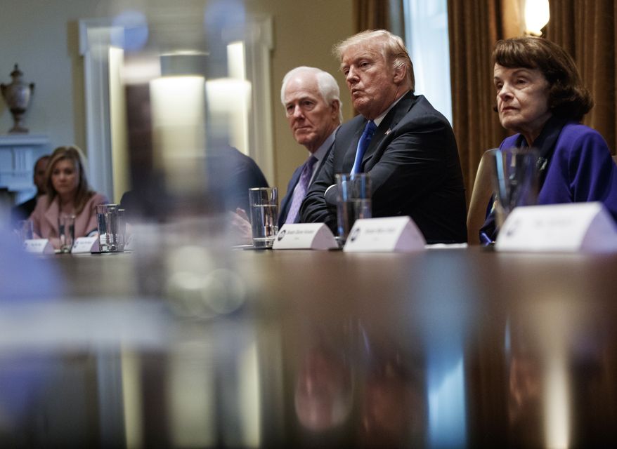 From far left, Rep. Marsha Blackburn, R-Tenn., Sen. John Cornyn, R-Texas, President Donald Trump and Sen. Dianne Feinstein, D-Calif., look across the table in the Cabinet Room of the White House, in Washington, Wednesday, Feb. 28, 2018, during a meeting with members of congress to discuss school and community safety. (AP Photo/Carolyn Kaster)
