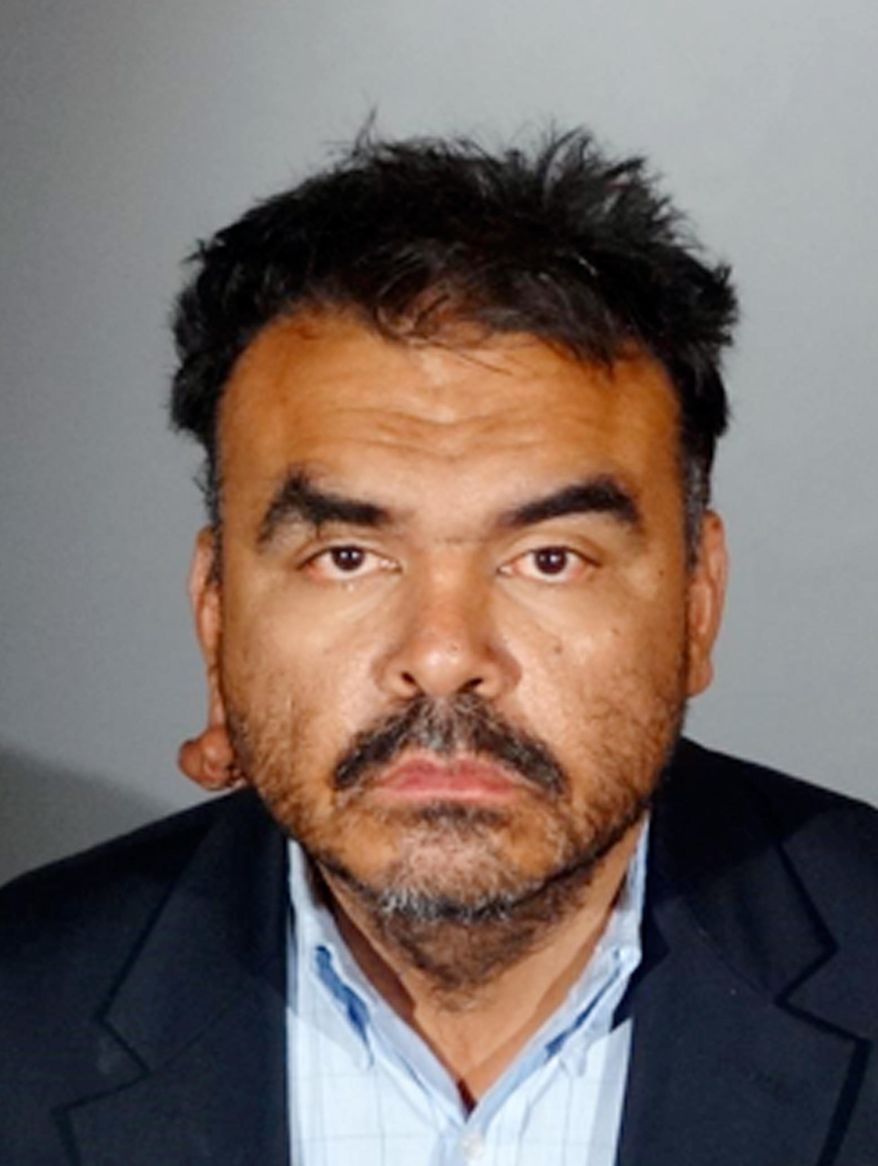This Feb. 27, 2018 booking photo provided by the Los Angeles Police Department shows Richard Colomo. Police say Colomo, a suspect in the random beating of an 86-year-old woman in Los Angeles, was re-arrested Tuesday on suspicion of felony elder abuse. The 41-year-old was arrested earlier this month and then released pending further investigation. Detectives say the victim, Mi Reum Song, was walking down the street when a man punched her in the face, causing her to fall and slam her head on the pavement. (Los Angeles Police Department via AP)