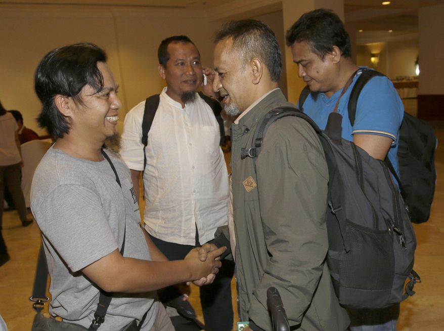 Reformed militants, from left to right, Zaenal Muttaqin, Toni Togar, Reza Sungkar, and Ramli, chat on the sidelines of a meeting with victims of attacks in Jakarta, Indonesia, Monday, Feb. 26, 2018. Indonesian government brought together dozens of convicted Islamic militants and survivors of attacks in what it hopes will be an important step in combating radicalism and fostering reconciliation. (AP Photo/Tatan Syuflana)