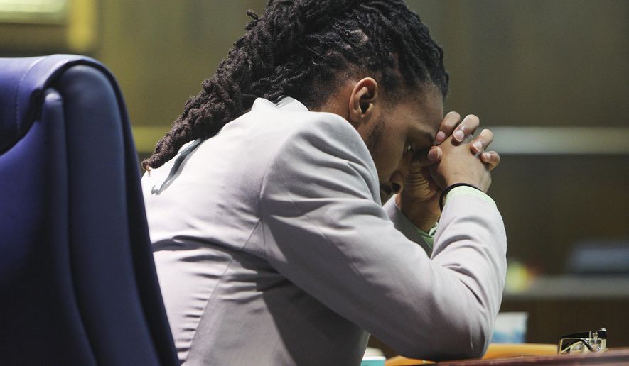 Johnthony Walker sits during a brief recess in his trial in Judge Don Poole's courtroom at the Hamilton County Courthouse in Chattanooga, Tenn., Tuesday, Feb. 27, 2018. Walker, a Tennessee school bus driver, was on his cellphone and driving 20 mph (30 kph) over the speed limit when he caused the crash that killed six elementary school students, a prosecutor said in court Tuesday. (Erin O. Smith/Chattanooga Times Free Press via AP)