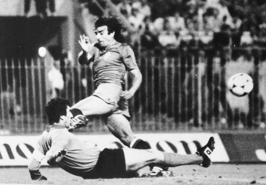 FILE - In this June 12, 1980 file photo, Italian goalkeeper Dino Zoff, on ground, saves a shot on goal by Spanish forward Quini during the Spain v Italy match in the European Soccer Championships at San Siro Stadium, Milan. Enrique Castro “Quini,” a striker who played for Barcelona and thrived in a long career with Sporting Gijon, has died of a heart attack on Tuesday, Feb. 27, 2018. He was 68. (AP Photo, File)