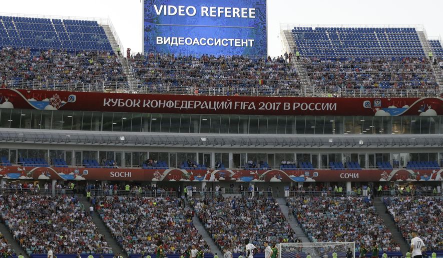 FILE - In this Sunday, June 25, 2017 file photo, a giant screen reports an incident is being investigated by VAR (Video Assistant Referee) during the Confederations Cup, Group B soccer match between Germany and Cameroon, at the Fisht Stadium in Sochi, Russia. FIFA has briefed coaches on how video assistant referees will operate at the World Cup. Although some trials have created additional confusion in games, soccer’s most significant adoption of technology is set to be formally voted into the laws of the game at a meeting on Saturday, March 3, 2018. (AP Photo/Thanassis Stavrakis, file)