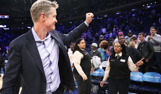 Golden State Warriors head coach Steve Kerr gestures toward supportive fans after the Warriors defeated the New York Knicks in an NBA basketball game, Monday, Feb. 26, 2018 in New York. (AP Photo/Kathy Willens)