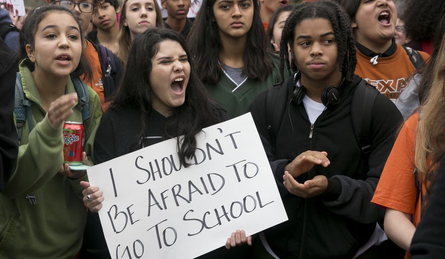 Maya Morales, 15, holds a sign during a walkout and demonstration for gun control at Anderson High School in Austin, Texas, on Friday Feb. 23, 2018. (Jay Janner/Austin American-Statesman via AP)