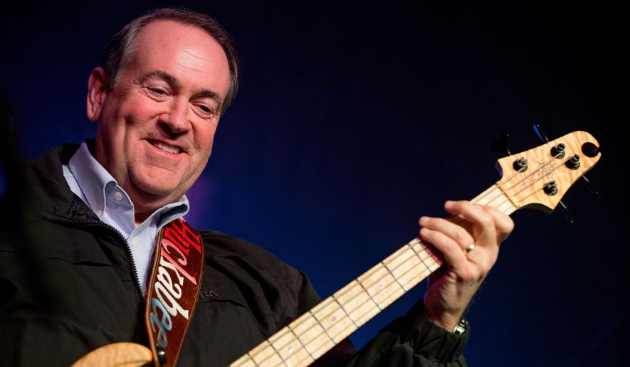 Republican presidential candidate former Arkansas Gov. Mike Huckabee plays bass guitar as he performs with the 80&#39;s rock band FireHouse at the Surf Ballroom in Clear Lake, Iowa, Friday, Jan. 22, 2016. In 2008, Huckabee performed at the ballroom, made famous for being the last venue Buddy Holly played before dying in a plane crash in 1959. (AP Photo/Andrew Harnik)