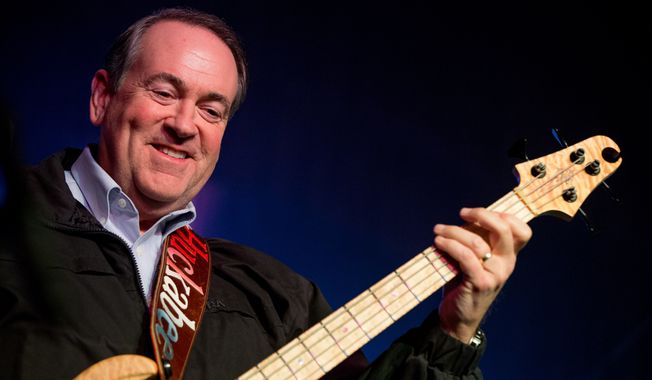 Republican presidential candidate former Arkansas Gov. Mike Huckabee plays bass guitar as he performs with the 80&#x27;s rock band FireHouse at the Surf Ballroom in Clear Lake, Iowa, Friday, Jan. 22, 2016. In 2008, Huckabee performed at the ballroom, made famous for being the last venue Buddy Holly played before dying in a plane crash in 1959. (AP Photo/Andrew Harnik)