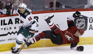 Minnesota Wild defenseman Jared Spurgeon (46) checks Arizona Coyotes right wing Richard Panik, right, to the ice during the second period of an NHL hockey game Thursday, March 1, 2018, in Glendale, Ariz. (AP Photo/Ross D. Franklin)