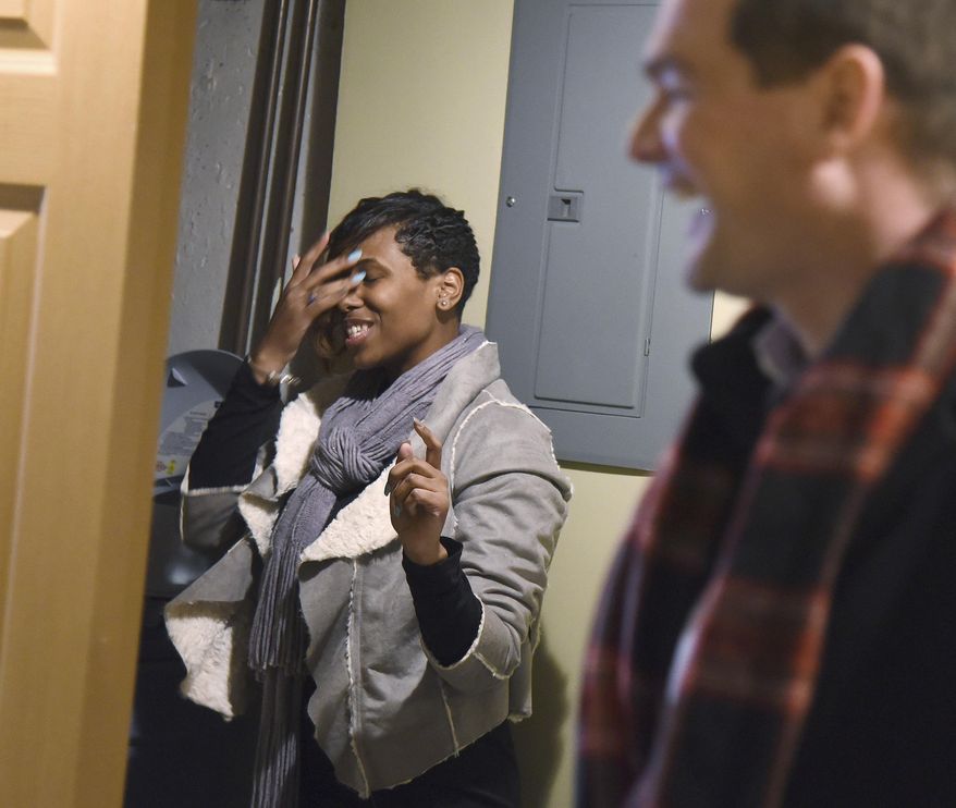 In this Feb. 6, 2018 photo, U.S. Navy Seaman Shynae Murphy is a little overwhelmed as she tours her finished basement on her first visit to her newly renovated, mortgage-free home in Algonquin, Ill. She was awarded the house through Homes on the Homefront, an Operation Homefront program that provides military families with mortgage-free residences and homeowner counseling. The houses are renovated and donated by corporate partners, in this case, JPMorgan Chase. (Rick West/Daily Herald, via AP)