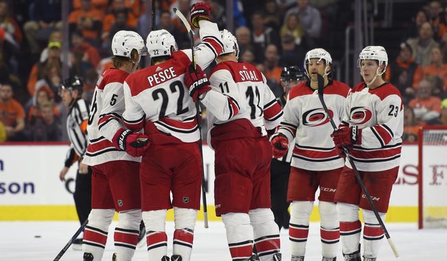 From left to right, Carolina Hurricanes&#x27; Noah Hanifin, Brett Pesce, Jordan Staal, Justin Williams and Brock McGinn celebrate after Williams scored a goal during the second period of an NHL hockey game against the Philadelphia Flyers, Thursday, March 1, 2018, in Philadelphia. (AP Photo/Derik Hamilton)