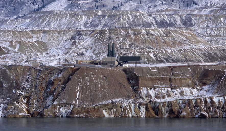 File - In this Dec. 14, 2016, file photo, the Horseshoe Bend Treatment Plant is seen at the far shore of the Berkeley Pit in Butte, Mont. Montana Resources and the Atlantic Richfield Company are planning to begin pumping and treating the toxic waters of a former open pit copper mine in Montana as soon as the end of this year. The Montana Standard reports Montana Resources on Monday, Feb. 26, 2018, announced the plan that will send the treated water from the Berkeley Pit in Butte to the Yankee Doodle Tailings Pond. (AP Photo/Matt Volz, File)