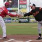 Philadelphia Phillies manager Gabe Kapler (22) shakes hands with Baltimore Orioles manager Buck Showalter before a baseball spring exhibition game, Saturday, Feb. 24, 2018, in Clearwater, Fla. (AP Photo/Lynne Sladky)