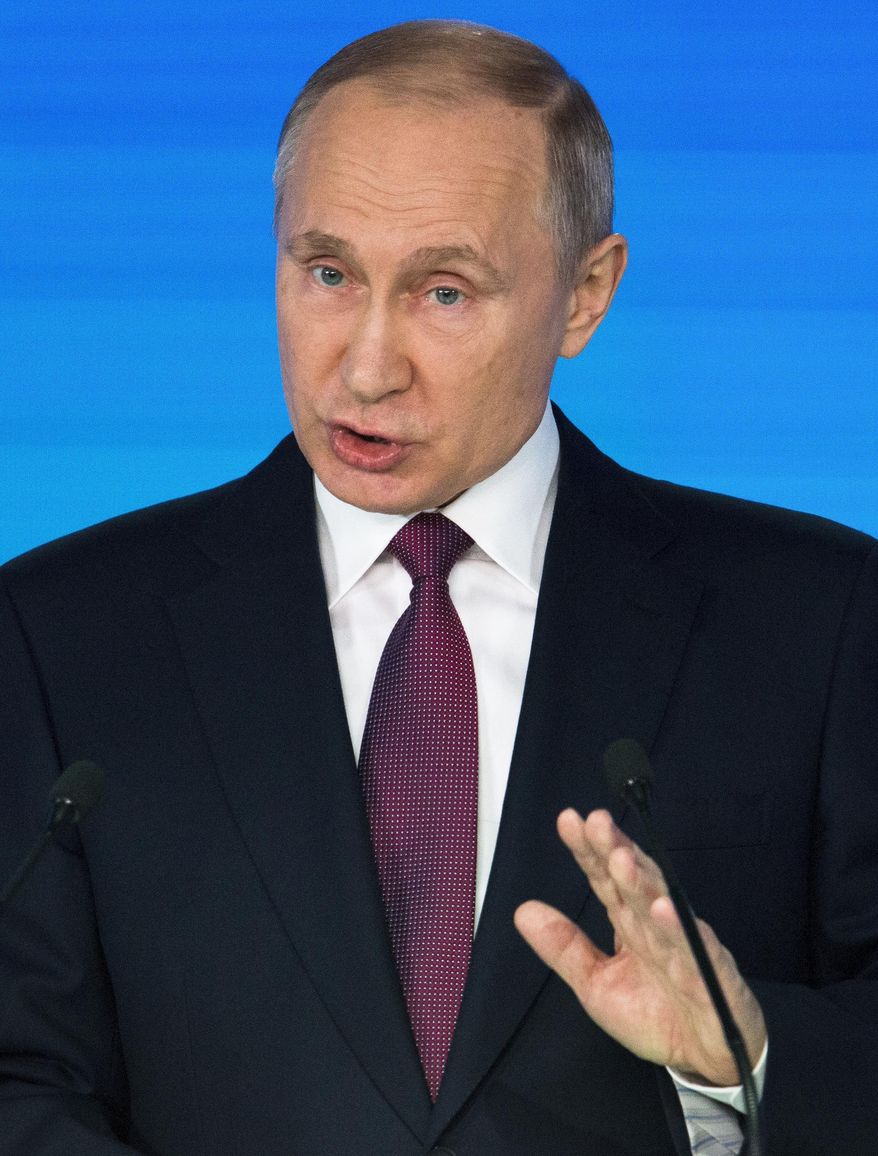 Russian President Vladimir Putin gives his annual state of the nation address in Manezh in Moscow, Russia, Thursday, March 1, 2018. Putin on Thursday boasted of new nuclear weapons and set a series of ambitious goals for Russia, vowing to boost living standards, improve health care and education and build modern infrastructure in a state-of-the-nation address. (AP Photo/Alexander Zemlianichenko)