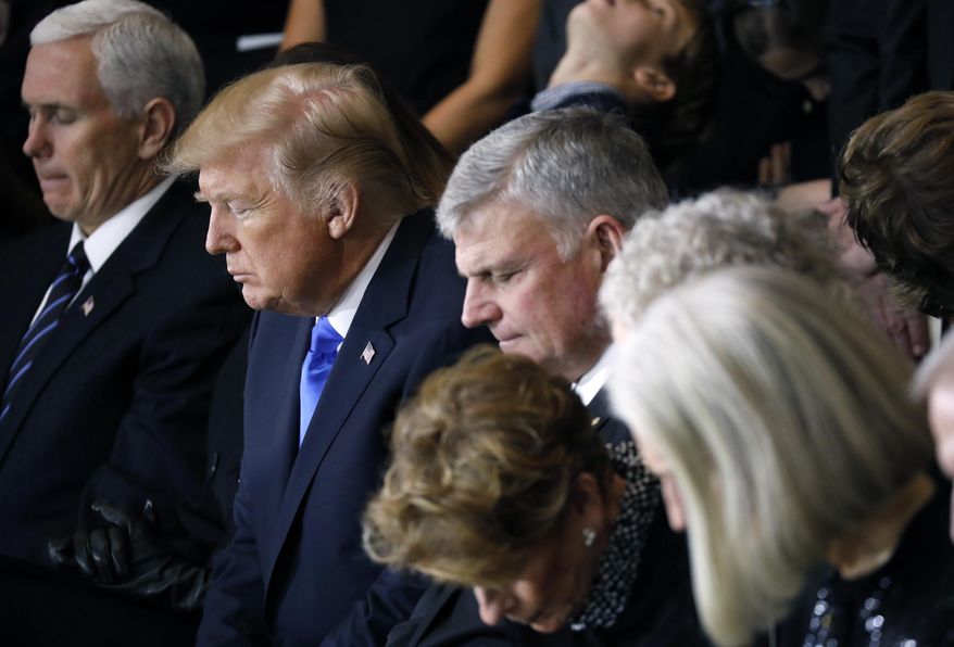 From left, Vice President Mike Pence, President Donald Trump, Franklin Graham and the Graham family, pray as the late Rev. Billy Graham lies in honor in the Rotunda of the U.S. Capitol in Washington, Wednesday, Feb. 28, 2018. (Aaron P. Bernstein/Pool via AP)