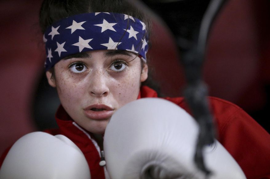 In this Feb. 7, 2018 photo, Natalie Dove prepares to punch a double-end bag as she works out at Philly's Next Champ boxing gym in Philadelphia. Just 16, Dove is a three-time winner of the prestigious National Women's Golden Gloves. In 2016, she fought her way onto Team USA with a second-place finish at the USA Boxing National Championships. Last year, Team USA ranked her the nation's No. 1 amateur junior woman boxer in her weight class. (Tim Tai/The Philadelphia Inquirer via AP)