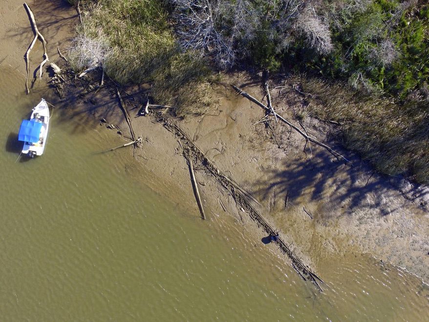 File - This Jan. 2, 2018, file photo shows the remains of a ship that could be the Clotilda, the last slave ship documented to have delivered captive Africans to the United States. The Clotilda was burned after docking in Mobile, Ala., in 1860, long after the importation of humans was banned, and experts say the remains found by a reporter from Al.com could be what is left of the long-lost wreck. (Ben Raines/AL.com via AP, File)