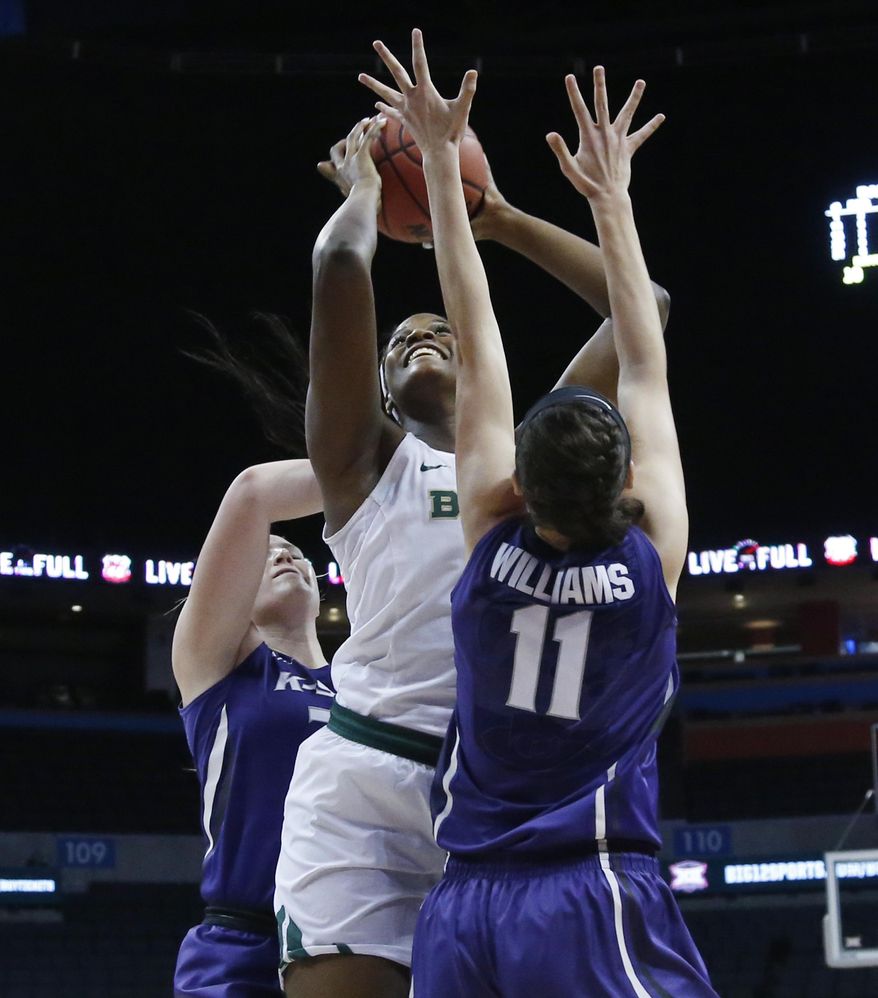 Baylor center Kalani Brown, center, shoots between Kansas State center Ashley Ray, left, and forward Peyton Williams (11) in the first half of an NCAA college basketball game in the quarterfinals of the women's Big 12 conference tournament in Oklahoma City, Saturday, March 3, 2016. (AP Photo/Sue Ogrocki)