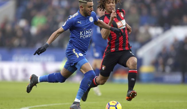 Leicester City&#x27;s Riyad Mahrez, left, and AFC Bournemouth&#x27;s Nathan Ake during the English Premier League soccer match at the King Power Stadium in Leicester, England, Saturday March 3, 2018. (Tim Goode/PA via AP)