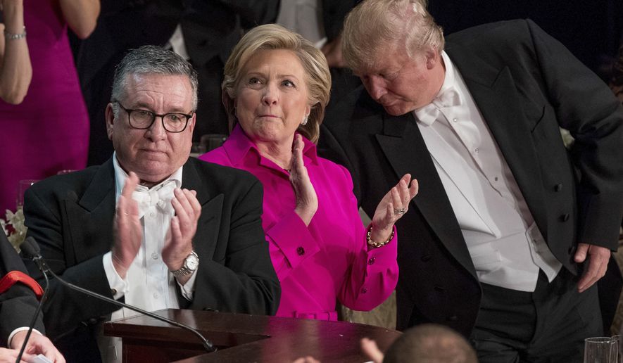 FILE - In this Oct. 20, 2016 file photo, from left, Alfred E. Smith IV, Democratic presidential candidate Hillary Clinton, and Republican presidential candidate Donald Trump stand to applaud during the 71st annual Alfred E. Smith Memorial Foundation Dinner in New York. Trump will venture into hostile territory Saturday, March 3, 2018 at the annual Gridiron dinner, mingling with members of the mainstream media he loves to lash out against. The white-tie gala is one of the city’s longest-running traditions, and the kind of establishment event that Trump has so far shunned. (AP Photo/Andrew Harnik, File)