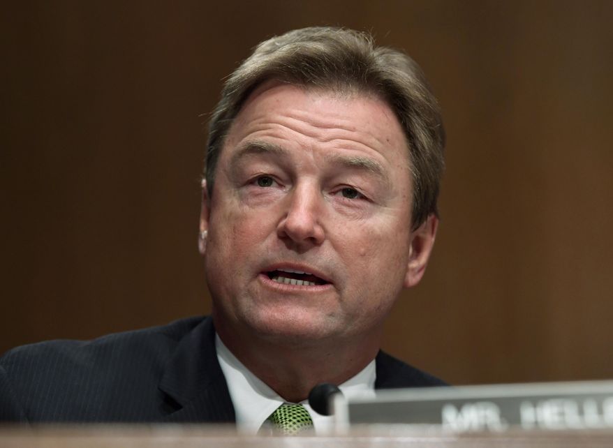 FILE - In this Jan. 30, 2018 file photo, Sen. Dean Heller, R-Nev., asks a question of Treasury Secretary Steven Mnuchin during a Senate Banking Committee hearing on Capitol Hill in Washington. The silent majority may stop Congress from doing anything to address gun violence. They include most Republicans and some vulnerable Democrats who would rather avoid the gun debate altogether than risk drawing unwanted attention from the NRA on the right or the growing movement of gun control advocates on the left. The elected officials ran from the gun debate in recent days, and when forced to talk about the issue, offered only murky answers that left unclear their positions on key proposals. (AP Photo/Susan Walsh)