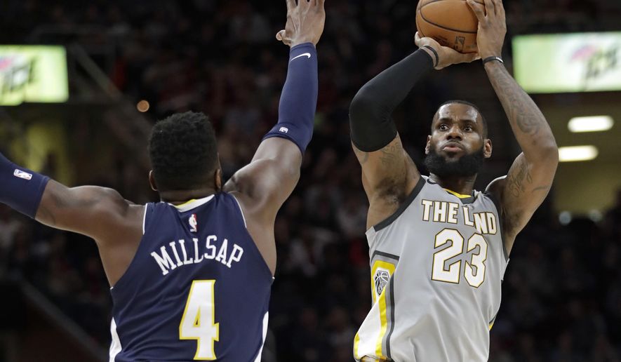 Cleveland Cavaliers' LeBron James (23) shoots over Denver Nuggets' Paul Millsap (4) in the first half of an NBA basketball game, Saturday, March 3, 2018, in Cleveland. (AP Photo/Tony Dejak)