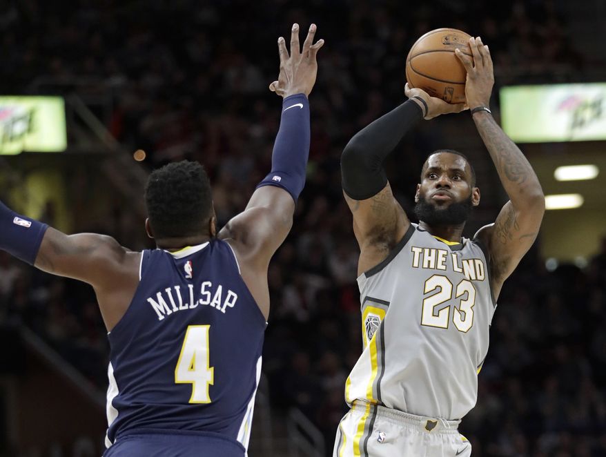 Cleveland Cavaliers' LeBron James (23) shoots over Denver Nuggets' Paul Millsap (4) in the first half of an NBA basketball game, Saturday, March 3, 2018, in Cleveland. (AP Photo/Tony Dejak)