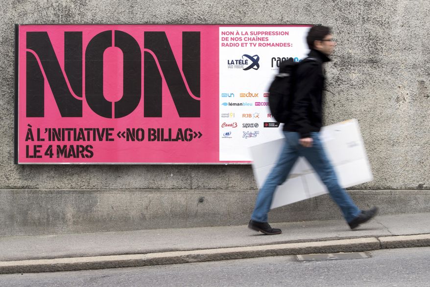 FILE - In this Feb. 9, 2018 photo a man passes by a sign asking to vote in the "No Billag" initiative in Fribourg, Switzerland. Swiss voters can decide in a referendum on March 4, 2018 on a proposal to stop the mandatory licence fee for services of the Swiss Broadcasting Corporation. (Anthony Anex/Keystone via AP)