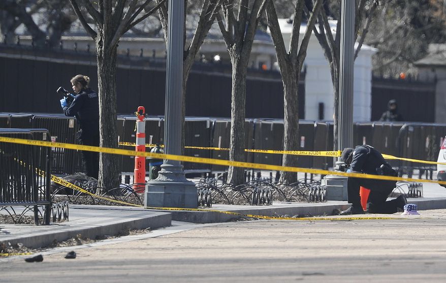 Law enforcement officers photograph the area in front of the White House in Washington, which is close to pedestrian traffic, Saturday, March 3, 2018. Authorities said a man shot himself to death outside the White House on Saturday. The District of Columbia Police Department says in a tweet that "adult male has been declared deceased. We are working to notify next of kin." That tweet comes about two hours after the Secret Service first reported that it was responding to reports of a self-inflicted shooting along the White House's north fence. (AP Photo/Pablo Martinez Monsivais)