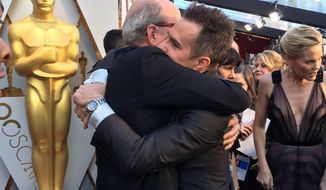 Best supporting actor nominees Richard Jenkins, left, and Sam Rockwell embrace on the red carpet at the 90th Annual Academy Awards on Sunday, March 4, 2018 at the Dolby Theatre in Los Angeles. (AP Photo/Sandy Cohen)