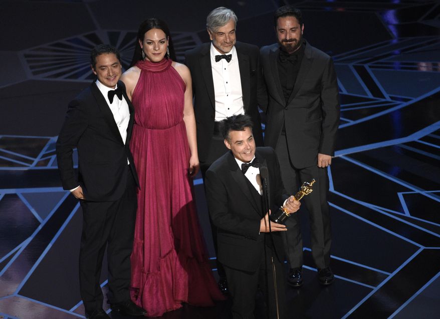 Sebastian Lelio, foreground center, and Nicolas Saavedra, from back left, Daniela Vega, Alejandro Goic, and Pablo Larrain accept the award for best foreign language film for "A Fantastic Woman" at the Oscars on Sunday, March 4, 2018, at the Dolby Theatre in Los Angeles. (Photo by Chris Pizzello/Invision/AP)