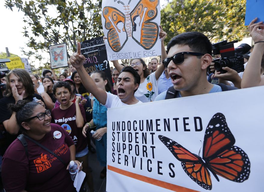 In this Sept. 1, 2017, file photo, undocumented students join a rally in support of the Deferred Action for Childhood Arrivals, or DACA program, outside the Edward Roybal Federal Building in downtown Los Angeles. A program that temporarily shields hundreds of thousands of young people from deportation was scheduled to end Monday, March 5, 2018, but court orders have forced the Trump administration to keep issuing renewals, easing the sense of urgency. (AP Photo/Damian Dovarganes, File)
