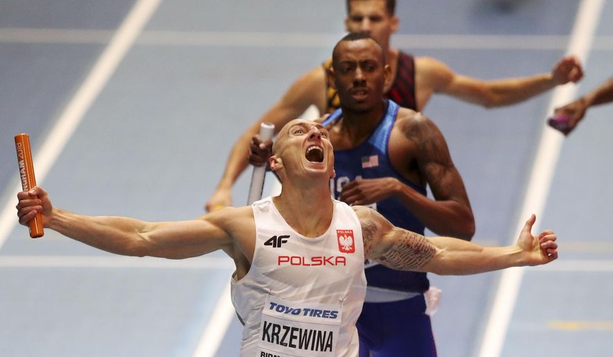 Poland's Jakub Krzewina celebrates after winning the gold medal in the men's 4x400-meter relay final at the World Athletics Indoor Championships in Birmingham, Britain, Sunday, March 4, 2018. (AP Photo/Alastair Grant)