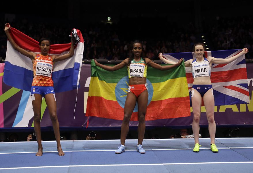Bronze medalist Netherlands' Sifan Hassan, gold medalist Ethiopia's Genzebe Dibaba and silver medalist Britain's Laura Muir celebrate after the women's 1500 meters race at the World Athletics Indoor Championships in Birmingham, Britain, Saturday, March 3, 2018. (AP Photo/Matt Dunham)
