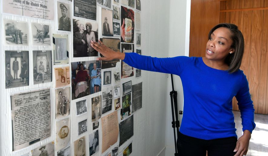 In this Tuesday, Jan. 30, 2018 photo, Fawn Weaver points to a photo on a wall of a room covered with photographs and documents related to the beginnings of Jack Daniel&#39;s whiskey at her farmhouse in Lynchburg, Tenn. Weaver had come to Lynchburg to research the roots of a former slave named Nathan &amp;quot;Nearest&amp;quot; Green, the man who some believed had taught the famous Jack Daniel to make whiskey more than 150 years ago (Shelley Mays /The Tennessean via AP)