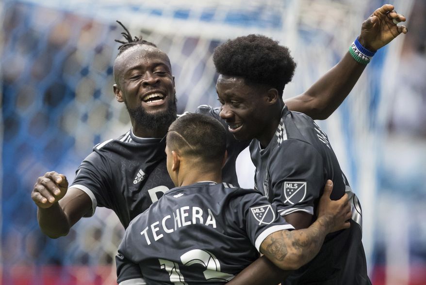 Vancouver Whitecaps' Kei Kamara, back left, Cristian Techera, front, and Alphonso Davies celebrate Davies' goal against the Montreal Impact during the second half of an MLS soccer game in Vancouver, British Columbia, Sunday, March 4, 2018. (Darryl Dyck/The Canadian Press via AP)