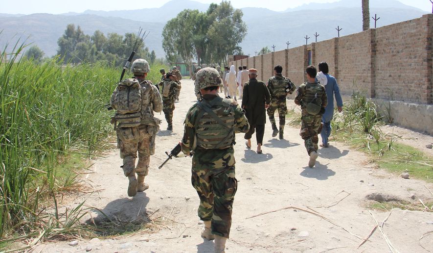 Afghan National Army troops from 201st Corps and 3rd Brigade Combat Team, 101st Airborne Division (AASLT) soldiers assigned to Train Advise Assist Command-East enter a village during a partnered force protection patrol in Laghman province Sept. 23, 2015. (U.S. Army photo by Capt. Jarrod Morris)