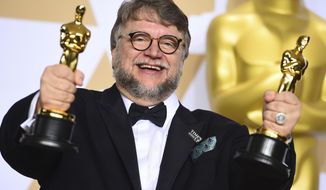 Guillermo del Toro, winner of the awards for best director and best picture for &amp;quot;The Shape of Water,&amp;quot; poses in the press room at the Oscars on Sunday, March 4, 2018, at the Dolby Theatre in Los Angeles. (Photo by Jordan Strauss/Invision/AP)