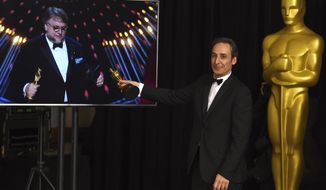 Alexandre Desplat, winner of the award for best original score for &amp;quot;The Shape of Water&amp;quot;, poses in the press room as Guillermo del Toro wins the award for best director for &amp;quot;The Shape of Water&amp;quot; at the Oscars on Sunday, March 4, 2018, at the Dolby Theatre in Los Angeles. (Photo by Jordan Strauss/Invision/AP)